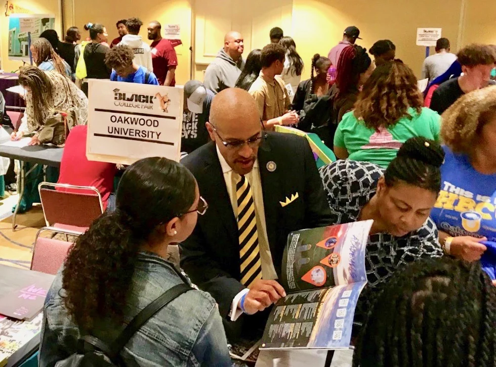 Dr. Nos engaging with attendees around a table