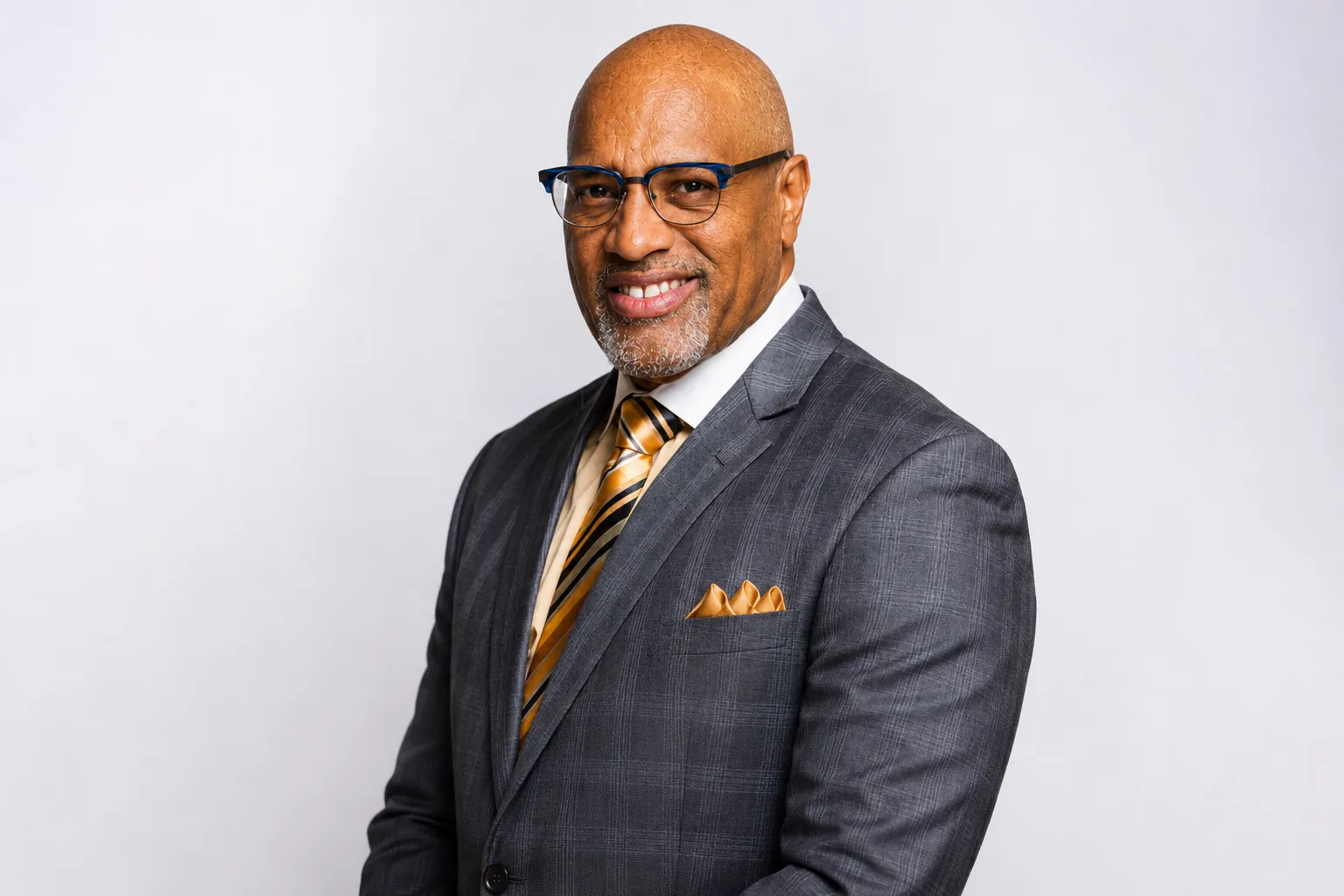 Dr. Nosakhere Thomas in a gray suit and gold tie