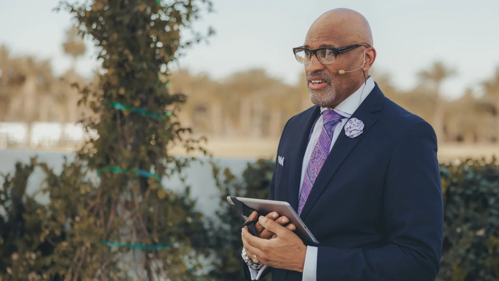 Dr. Nos speaking at an outdoor gathering